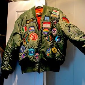 Size Large green flight jacket with patches on front, back and sides